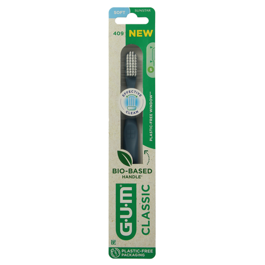 GUM Classic soft toothbrush with medium-sized head, displaying white handle and bristles for gentle cleaning.