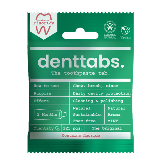Denttabs vegan fluoride toothpaste tablets with mint flavor, 125 count, displayed in a clear container.