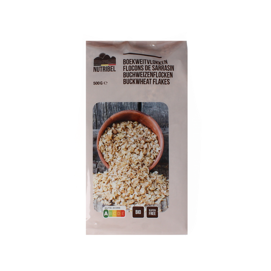 Nutribel glutenvrije boekweitvlokken ontbijtgranen in 500g verpakking, shown in a clear image with textured flake details.