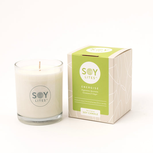 Soylites energizing soy candle in 220ml glass jar with orange and yellow flames, emitting warm light.