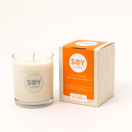 Soylites gratitude soy candle in a 220ml container, natural beige color, with a wick ready for burning, designed for home ambiance.