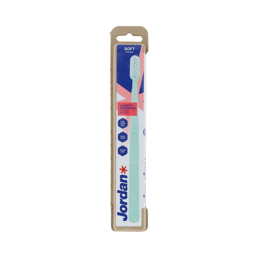 Jordan Clean Smile Care Soft toothbrush, 1 pack, showing a close-up of the soft-bristled toothbrush with pink and white handle.