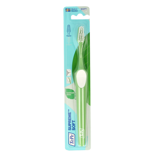 TePe Supreme toothbrush in white, designed for effective oral cleaning, with a sleek handle and soft bristles.