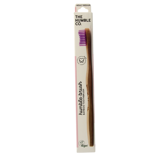 The Humble Co bamboo medium purple toothbrush with soft bristles for gentle cleaning, displayed against a plain background.