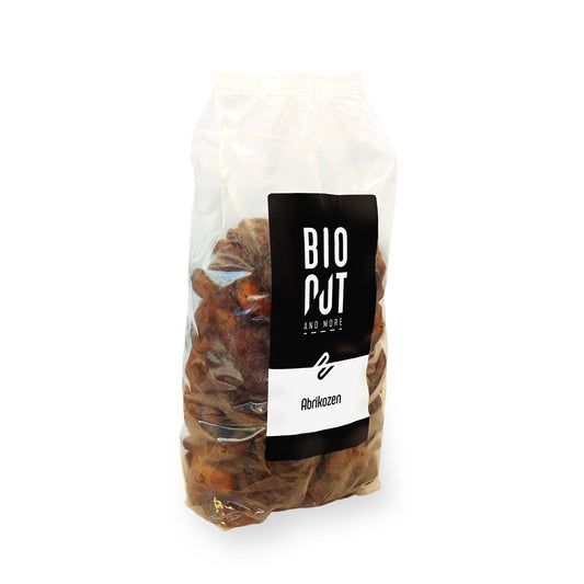 Bionut organic apricots in a 1kg package, fresh and ripe, displayed in a basket with green leaves