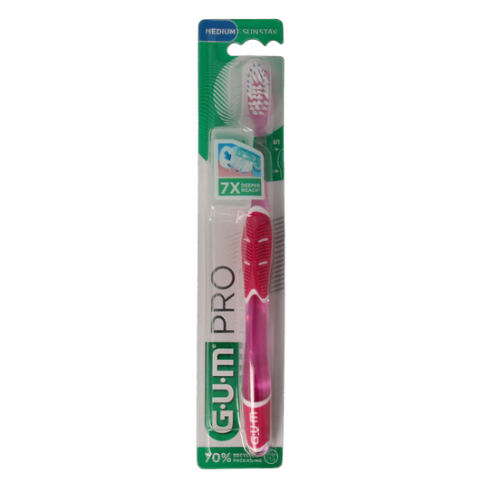 GUM Technique Pro Medium toothbrush showing soft bristles and ergonomic handle for effective oral cleaning.