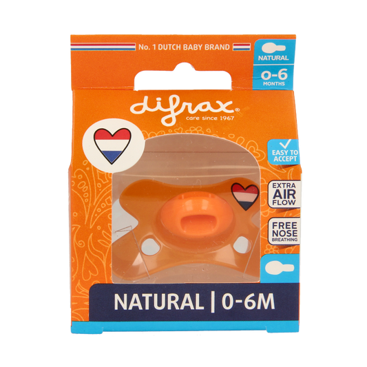 Difrax baby pacifier for 0-6 months, designed for infants, in a natural setting showing the soft nipple and packaging.