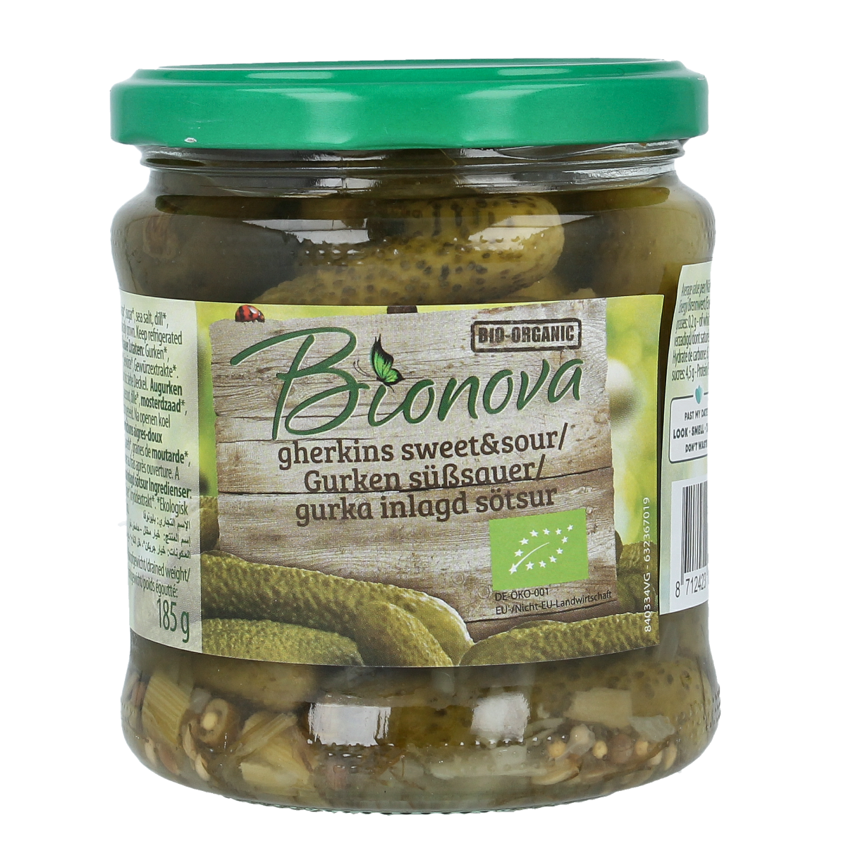 Bionova sweet and sour organic gherkins in a 330g jar, shown with fresh vegetables and fruits in the background.