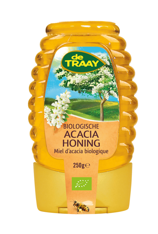 de Traay organic acacia honey in a 250g squeeze bottle, golden honey drizzling from the nozzle