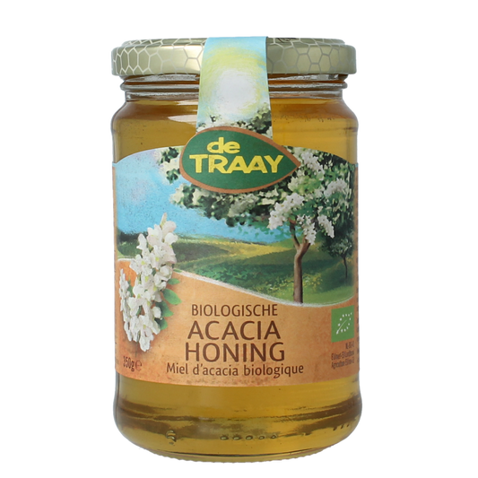 Glass jar of de Traay organic acacia honey, 350 grams, showcasing smooth, golden honey with a clear label.