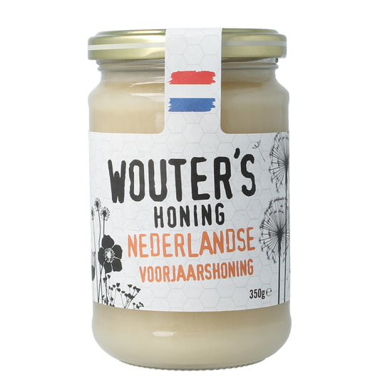 De Traay Wouters Nederlandse voorjaarshoning in 350g jar, golden honey with a smooth texture, displayed in a clear glass jar.