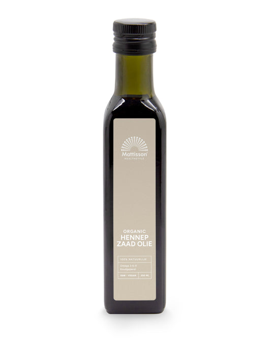 Raw cold-pressed organic hemp seed oil by Mattisson in a 250ml bottle, shown in a clear glass container with hemp seeds nearby.
