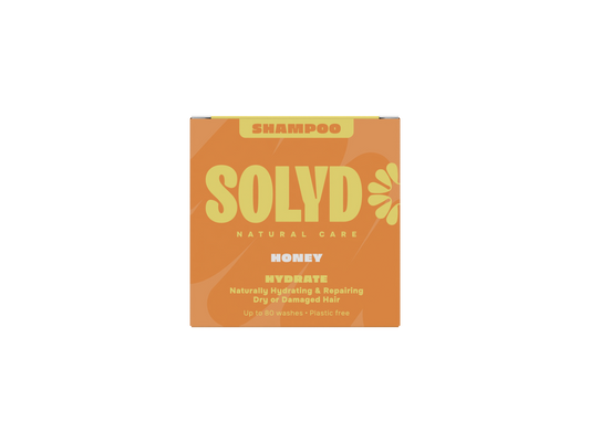 Solyd Honey Shampoo Bar for hair care, 60g, in a rectangular shape with honey-colored appearance and textured surface.