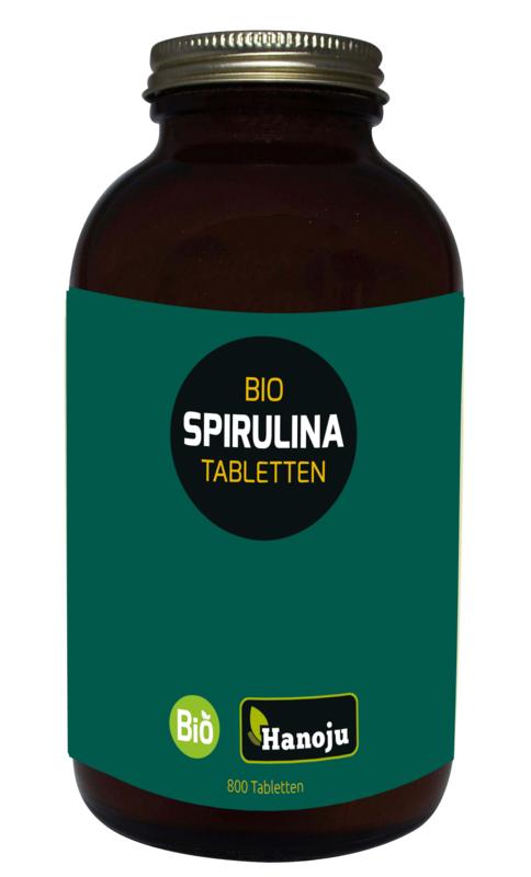 Hanoju Spirulina 400mg organic tablets in a glass bottle, herbal supplement, eco-friendly packaging, displayed on a white background.