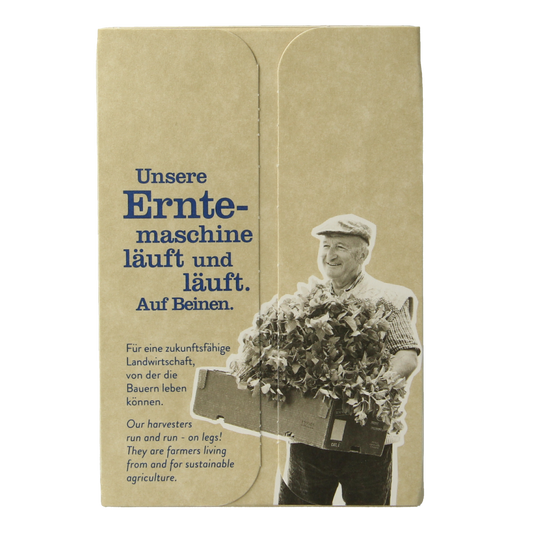 Organic Sonnentor Assam English black tea in a box of 18 tea bags, featuring dark tea leaves and packaging.