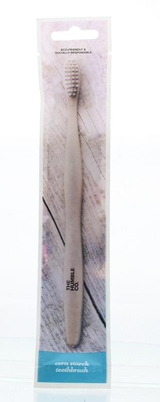 The Humble Co bioplastic adult toothbrush with medium bristles and white handle, designed for effective oral cleaning.