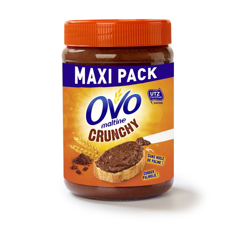 Ovomaltine Crunchy Cream spread on bread, 660g jar, chocolate and malt flavor, creamy texture, Ovomaltine brand.